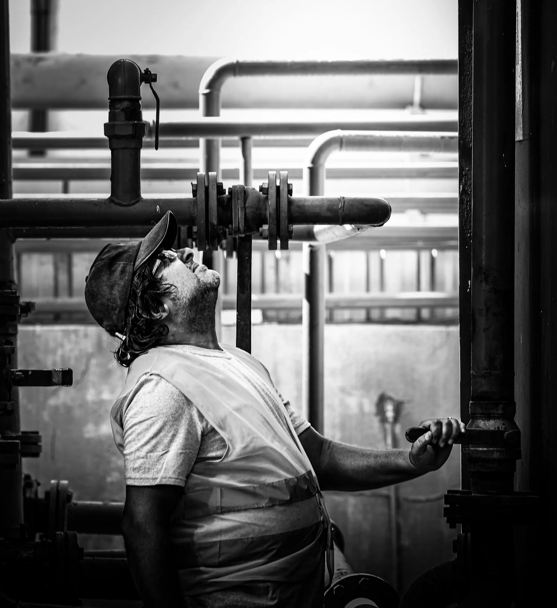Technician at work among pipes