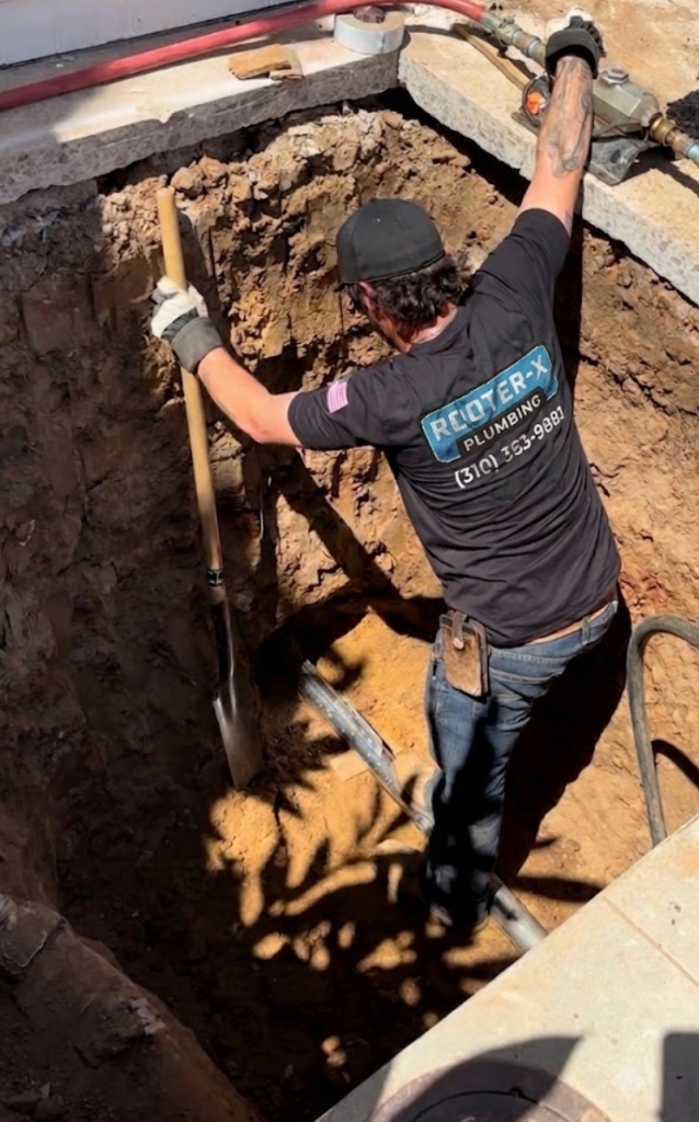 Rooter-X Plumbing technician executing main sewer trench excavation